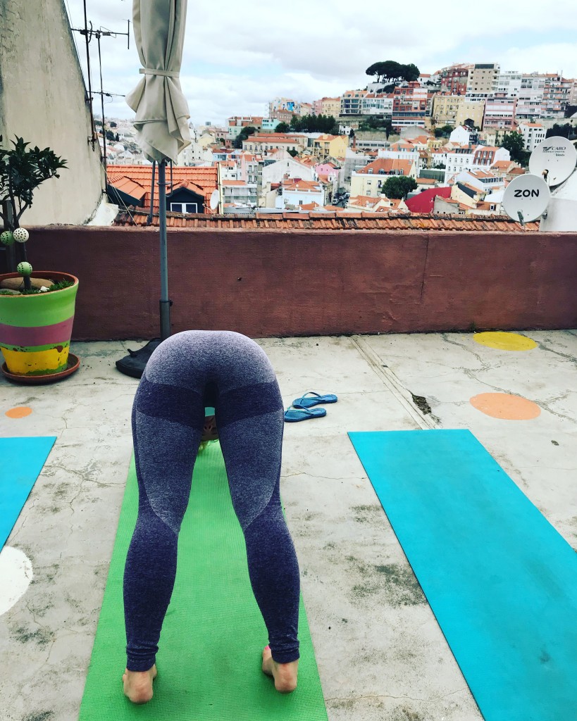 rooftop yoga class lisbon portugal downward dog pose